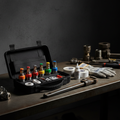 Emergency repair kit open on workbench with color-coded temperature-rated sprinkler heads, seal tape and shut-off tool